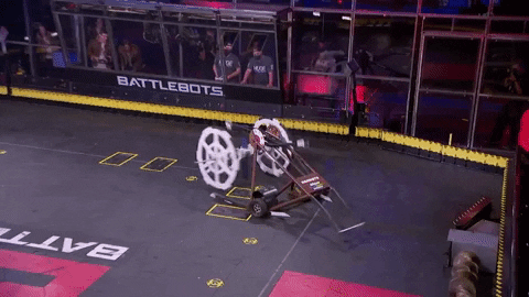 gif of a battlebot fight where one robot flips in the air after striking the other robot